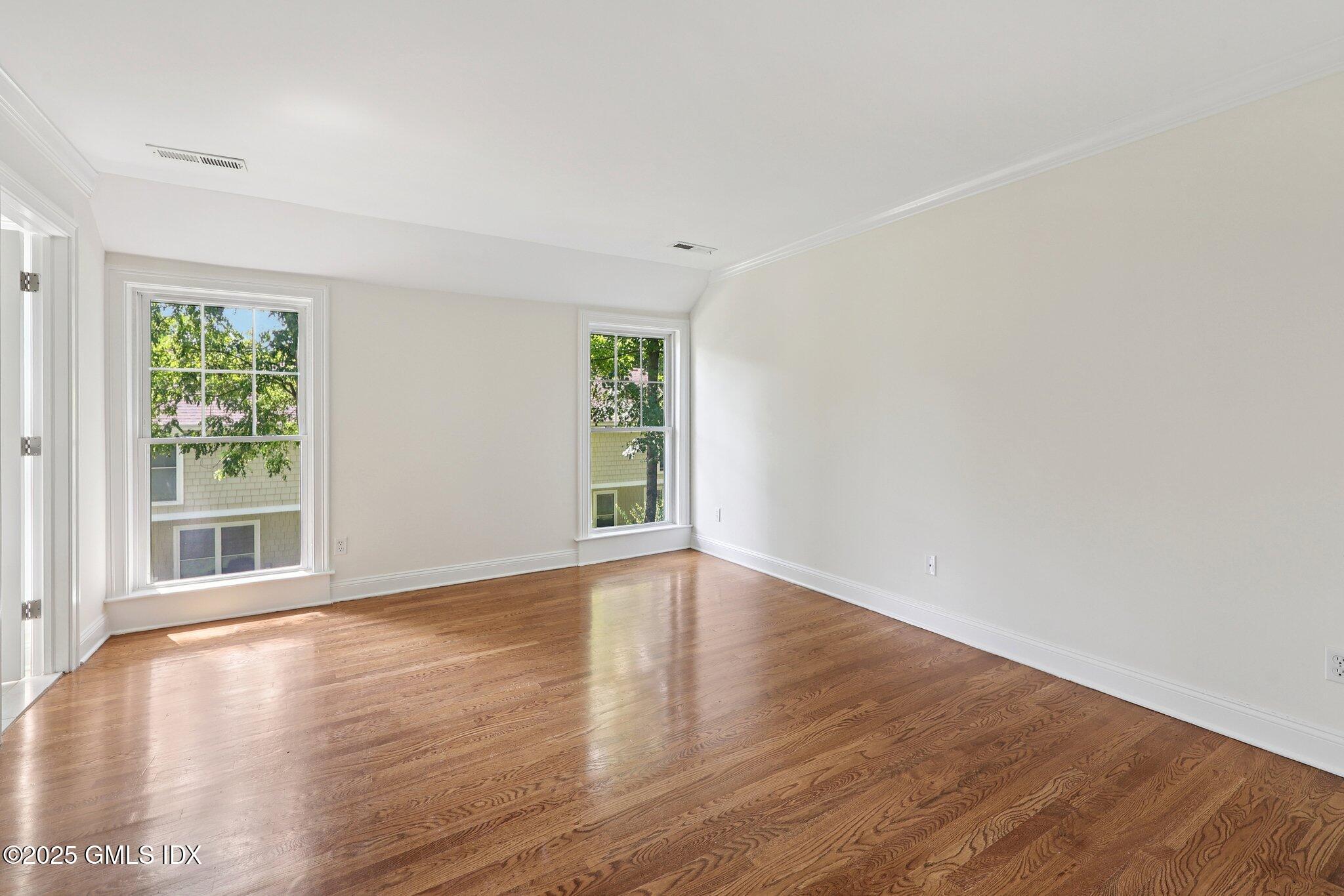 251 Weaver Street, Unit 1C Greenwich, CT 06831 - Photo 17 of 29 a view of empty room with wooden floor and fan