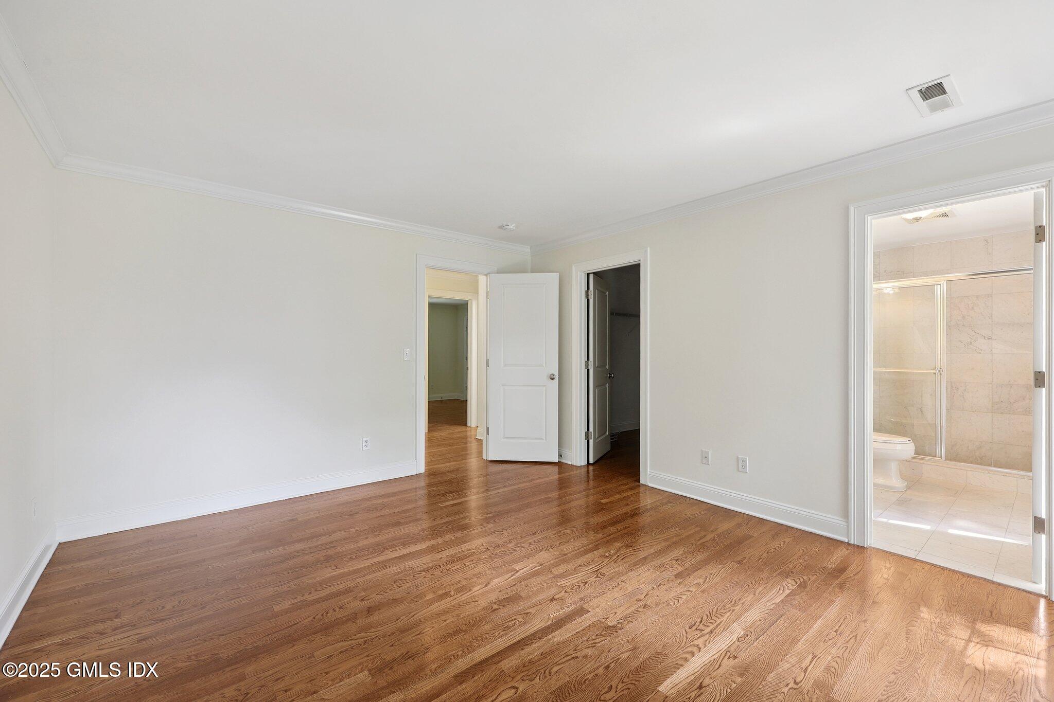 251 Weaver Street, Unit 1C Greenwich, CT 06831 - Photo 18 of 29 a view of an empty room with wooden floor