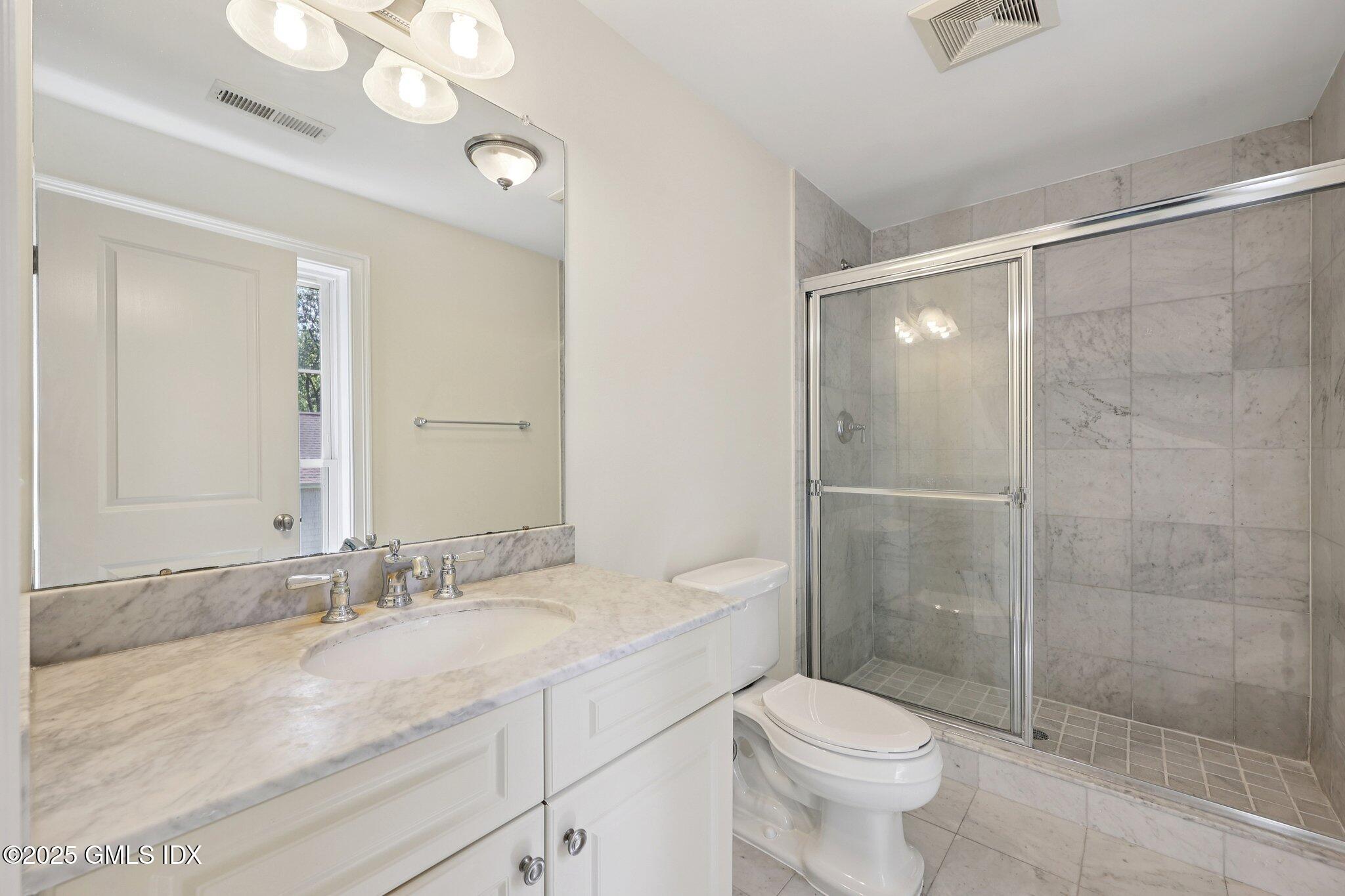 251 Weaver Street, Unit 1C Greenwich, CT 06831 - Photo 19 of 29 a bathroom with a sink a toilet and shower