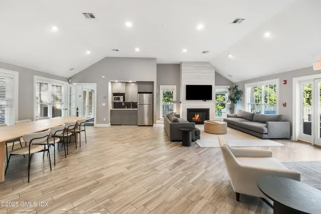 a living room with furniture a flat screen tv and a fireplace