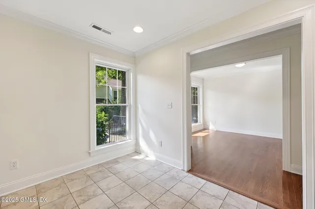 an empty room with windows and closet