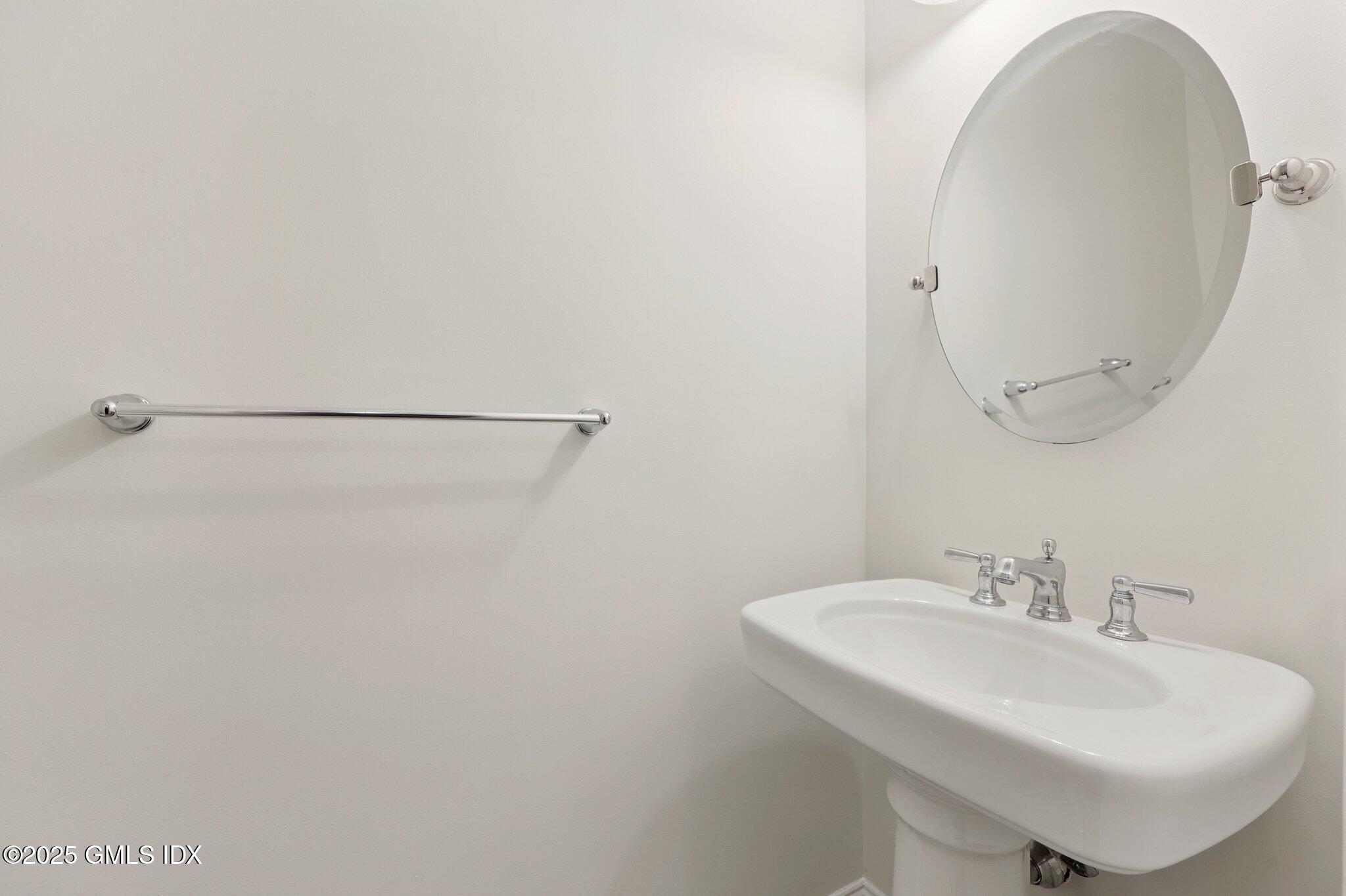 251 Weaver Street, Unit 1C Greenwich, CT 06831 - Photo 7 of 29 a bathroom with a sink and a mirror