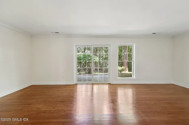 a view of wooden floor and windows in a room