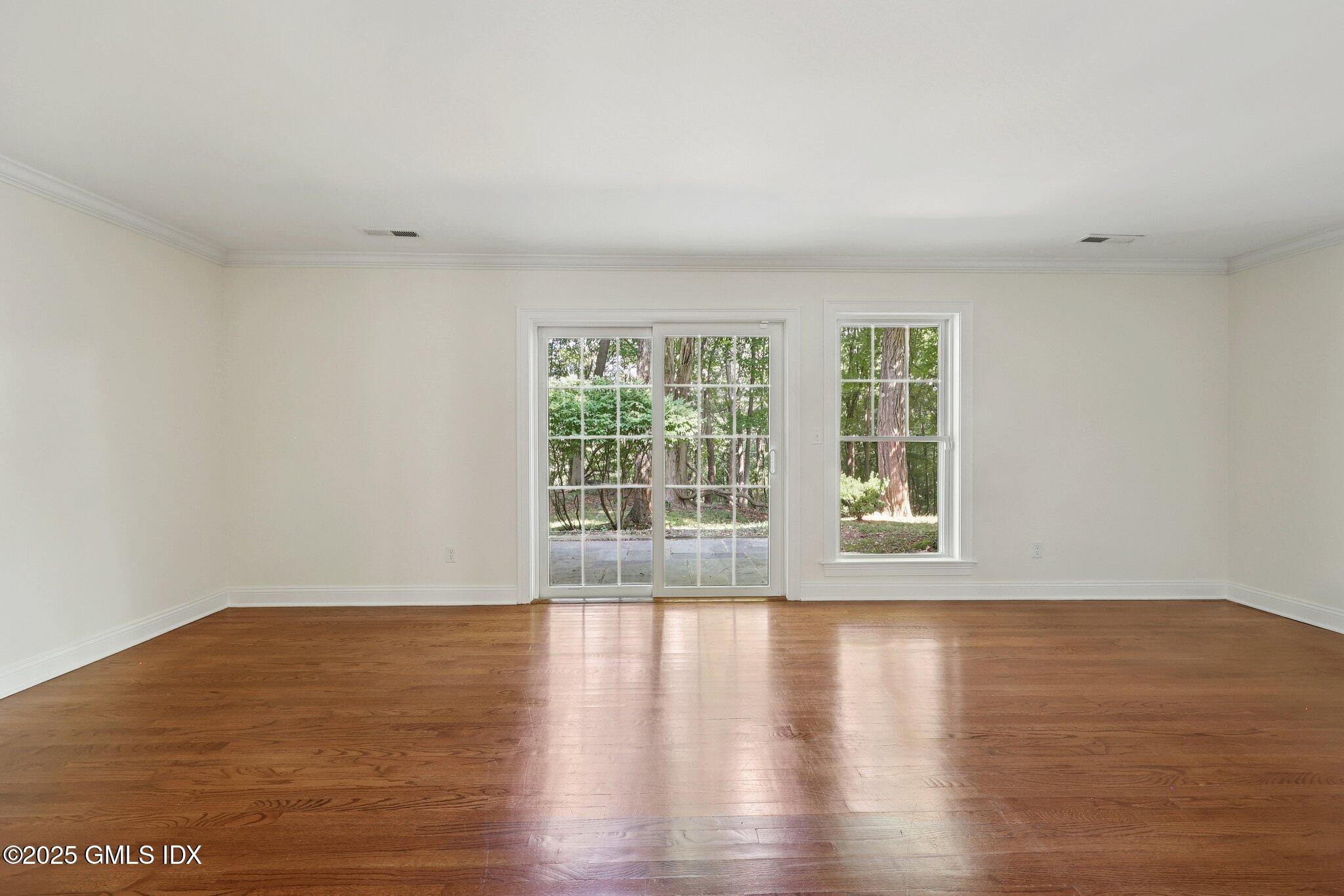 251 Weaver Street, Unit 1C Greenwich, CT 06831 - Photo 9 of 29 a view of wooden floor and windows in a room