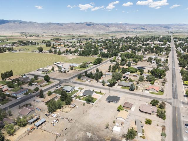 51 West 500 South Monroe, UT 84754 - Photo 36 of 41 Aerial perspective showcasing a community with diverse residential properties, expansive open land, and established roadways