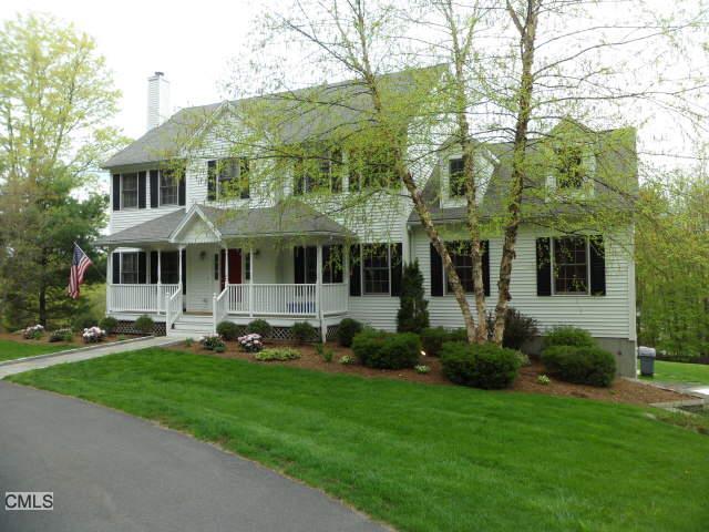 59 Turkey Roost Road Monroe, CT 06468 - Photo 1 of 1 a front view of a house with a yard table and chairs