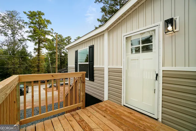 a view of balcony with wooden floor and fence