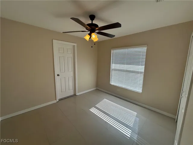 a view of room with window and ceiling fan