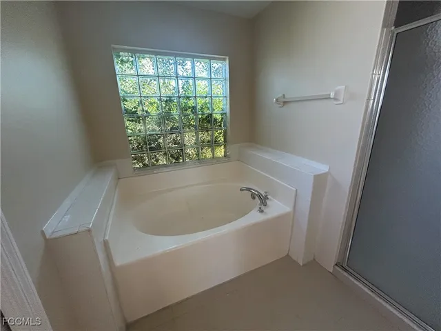 a bathroom with a bathtub and window