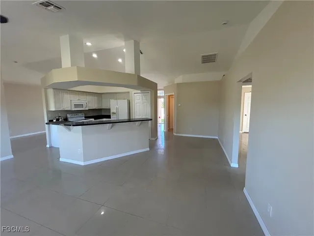 a kitchen with stainless steel appliances a refrigerator and a stove top oven