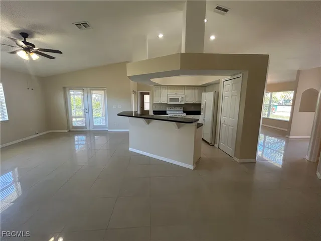 a kitchen with stainless steel appliances granite countertop a sink a stove and a refrigerator
