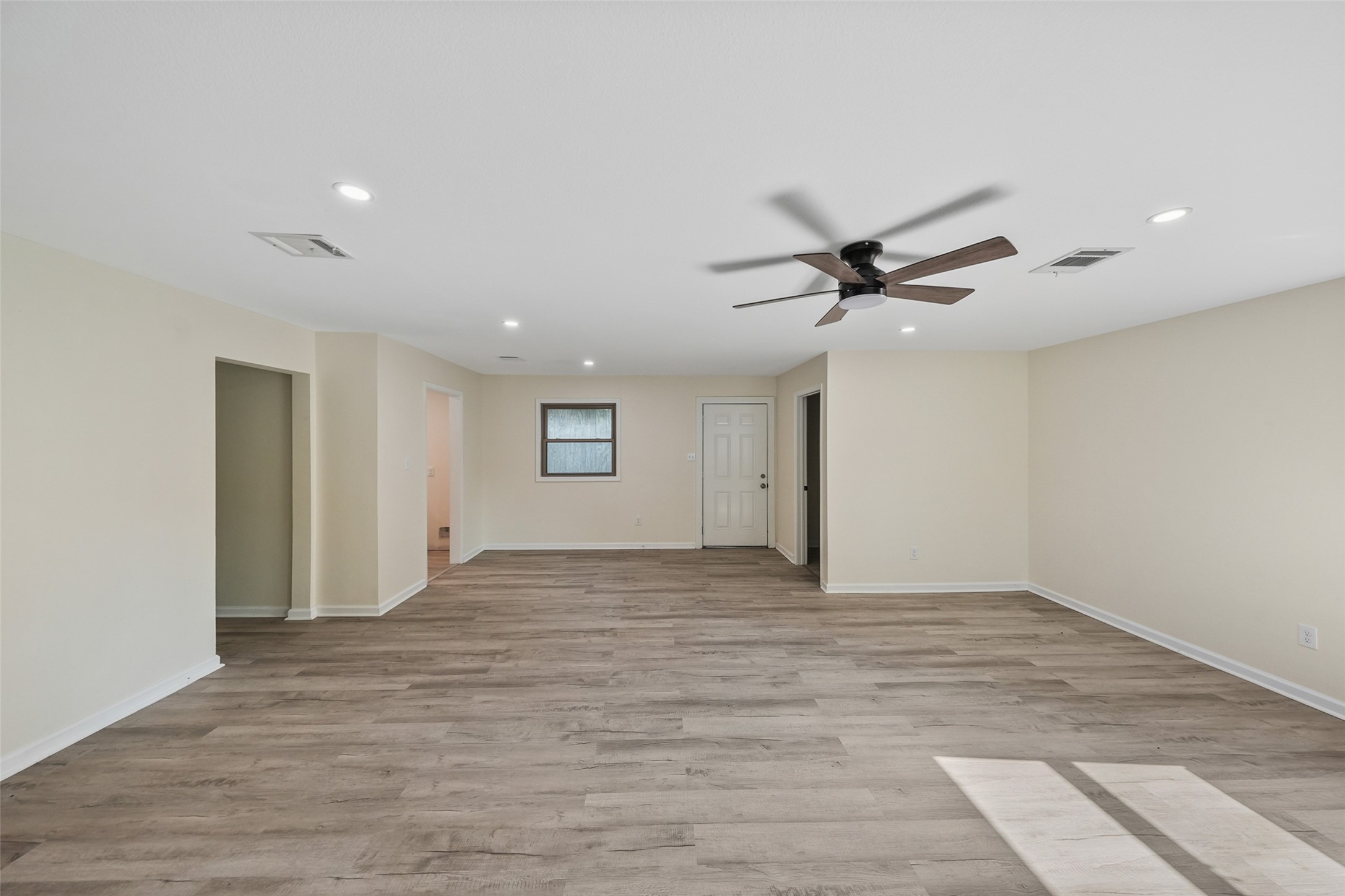 725 Lafayette Street Hempstead, TX 77445 - Photo 9 of 20 Open living area with updated flooring and ceiling fan
