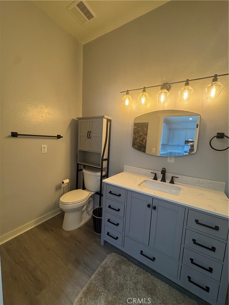 46685 Benito Wilson Road, Unit ADU Big Bear City, CA 92314 - Photo 14 of 19 a bathroom with a toilet sink and mirror