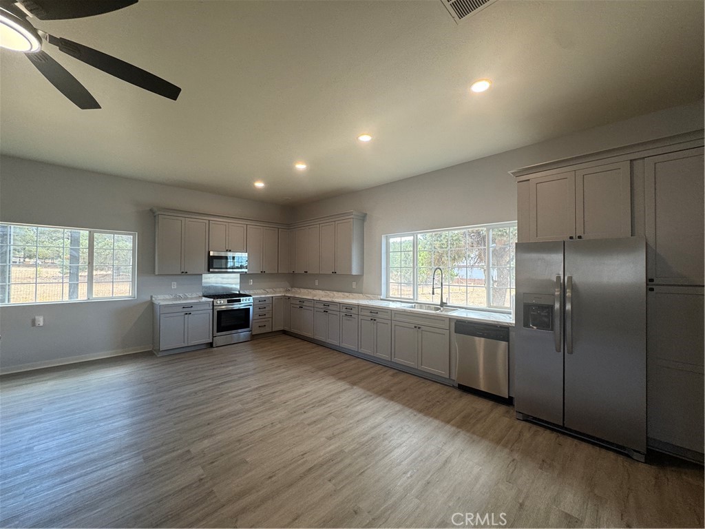 46685 Benito Wilson Road, Unit ADU Big Bear City, CA 92314 - Photo 7 of 19 a kitchen with stainless steel appliances a refrigerator sink and cabinets