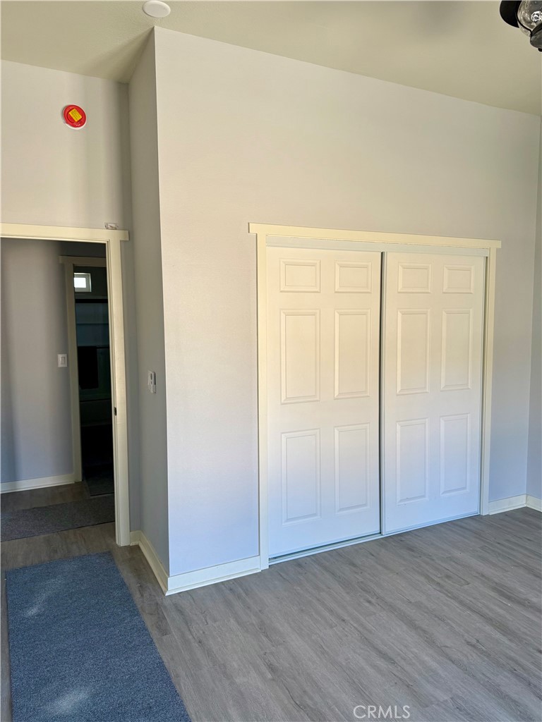 46685 Benito Wilson Road, Unit ADU Big Bear City, CA 92314 - Photo 10 of 19 an empty room with wooden floor and closet