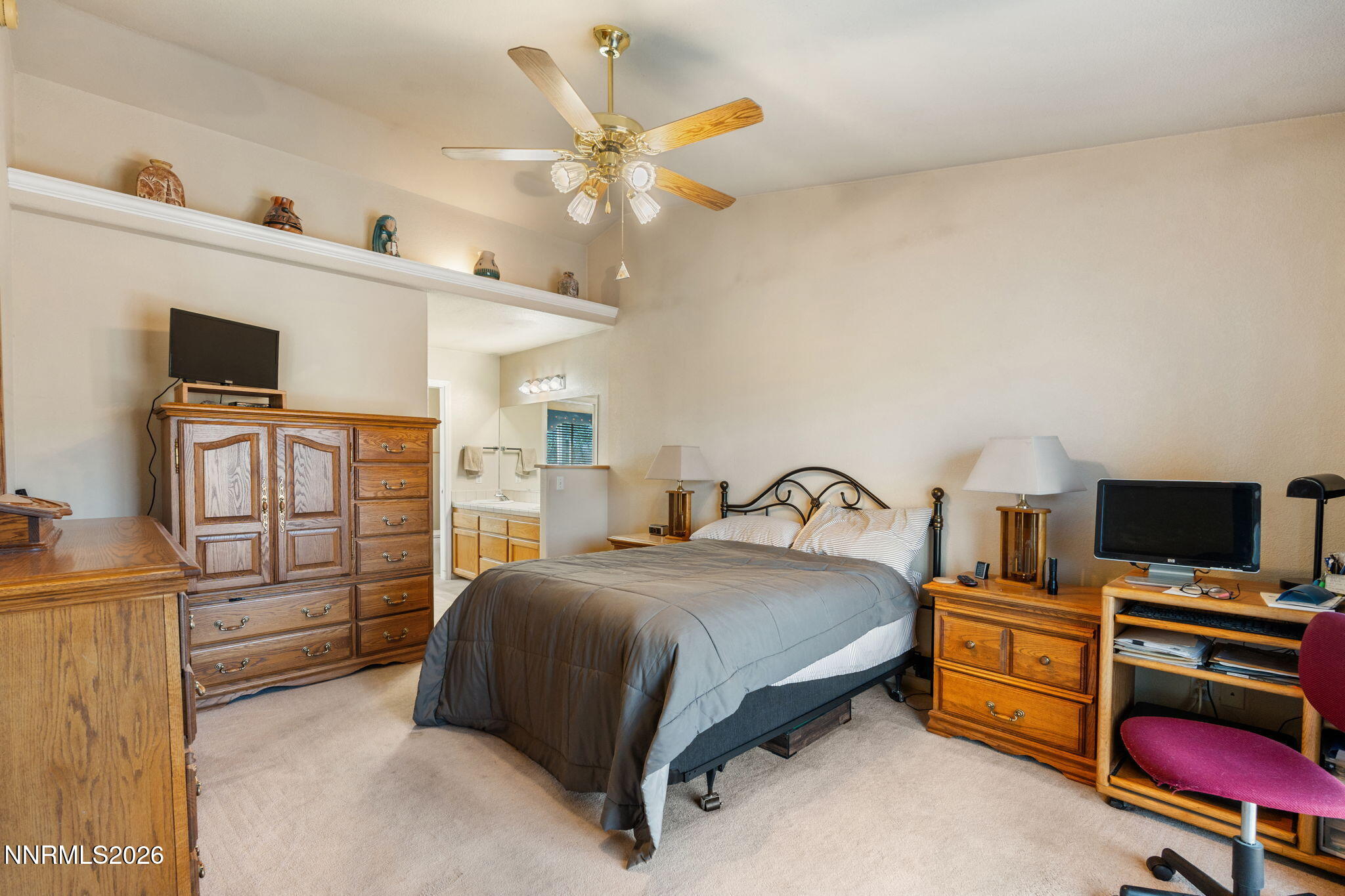 219 David Avenue Stagecoach, NV 89429 - Photo 14 of 40 a bedroom with a bed and a flat screen tv