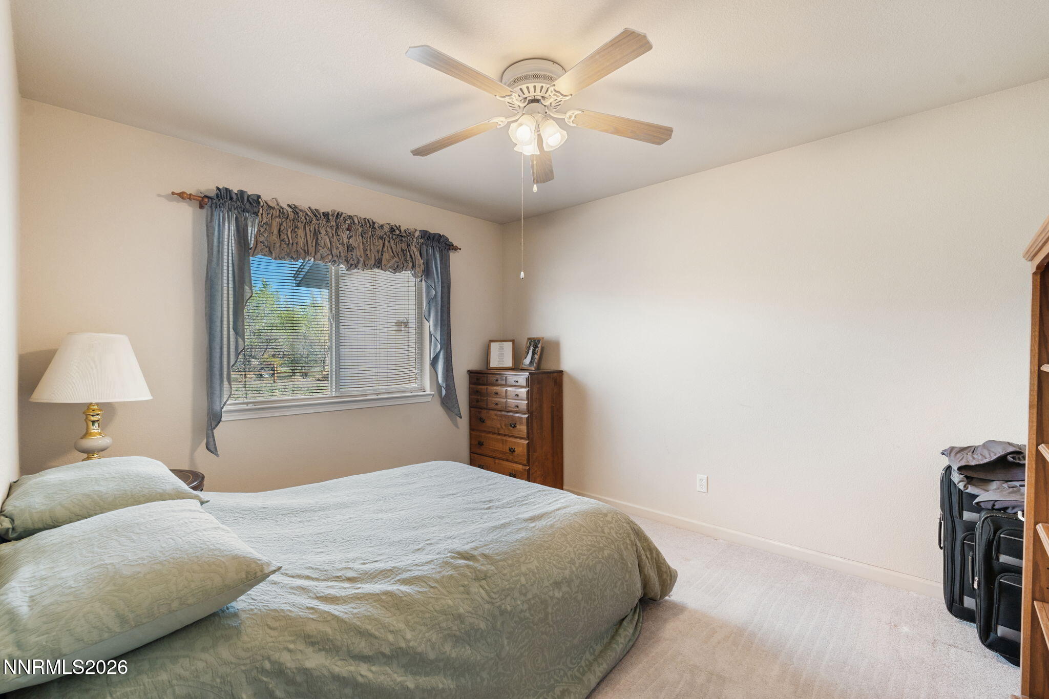 219 David Avenue Stagecoach, NV 89429 - Photo 16 of 40 a bedroom with a bed and a chandelier