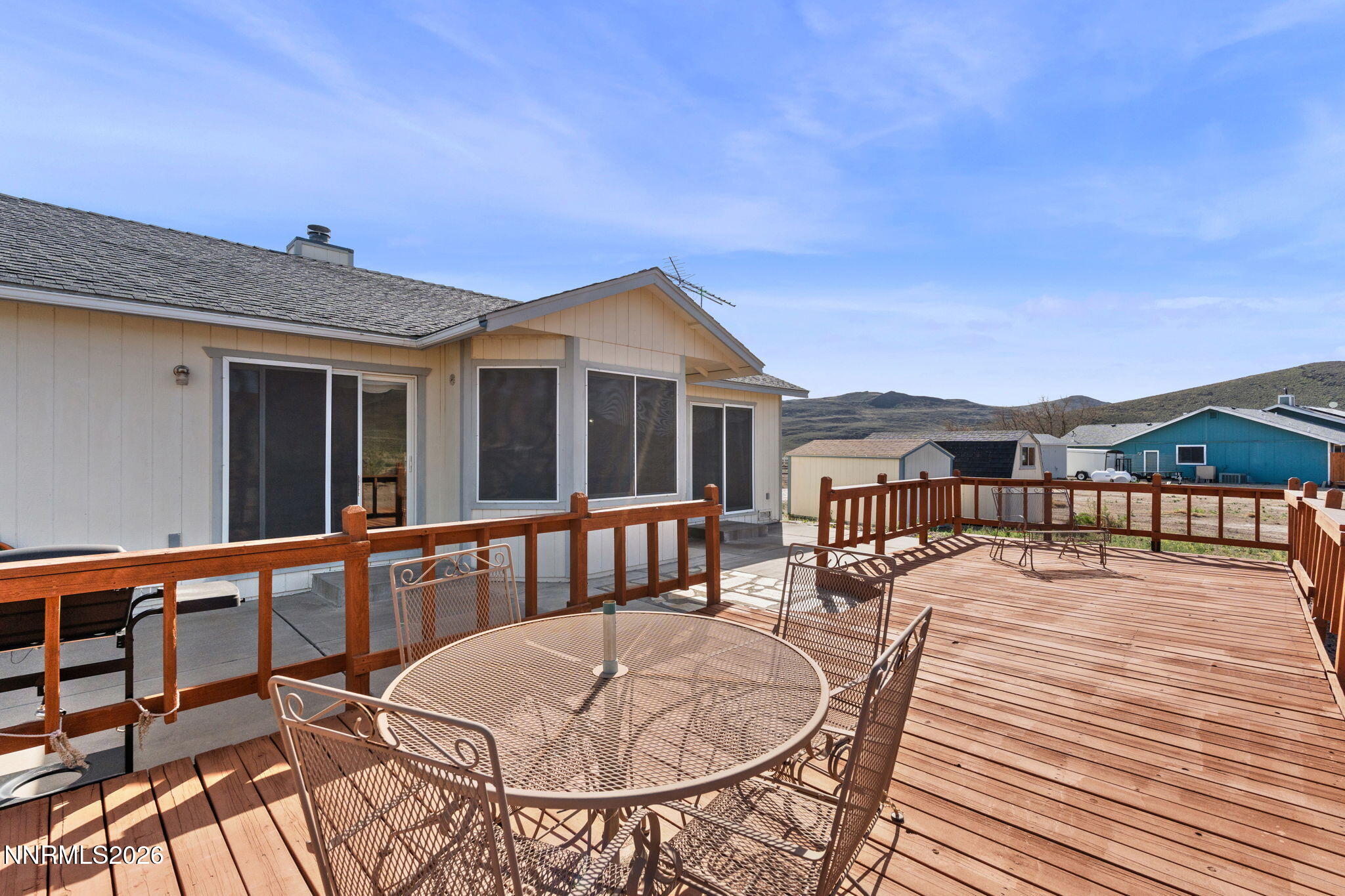 219 David Avenue Stagecoach, NV 89429 - Photo 22 of 40 a view of a patio with couches chairs and a table and chairs with wooden floor