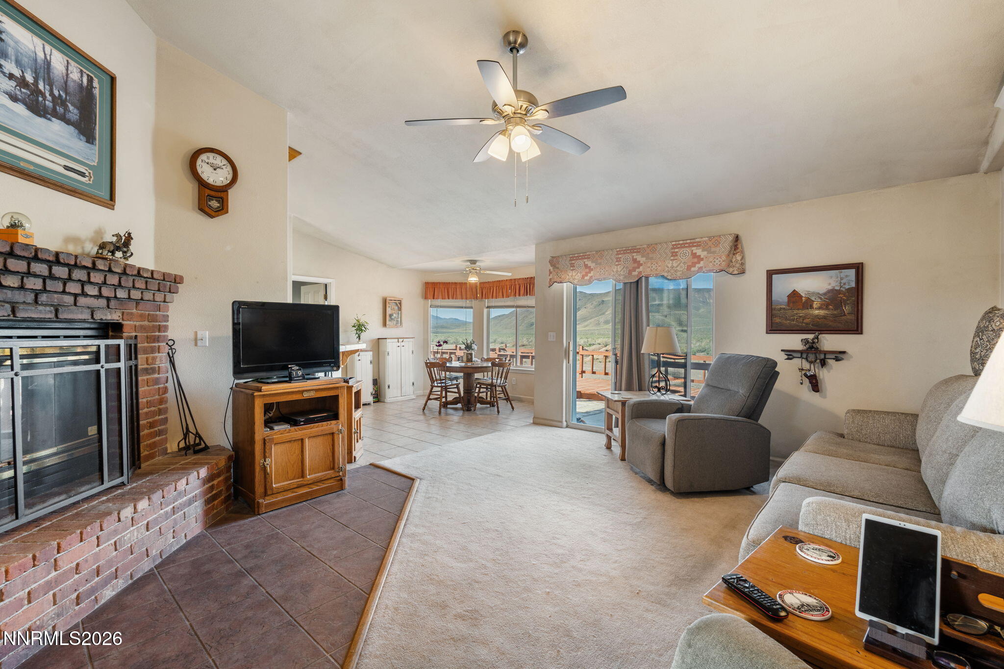 219 David Avenue Stagecoach, NV 89429 - Photo 5 of 40 a living room with furniture a flat screen tv and a fireplace