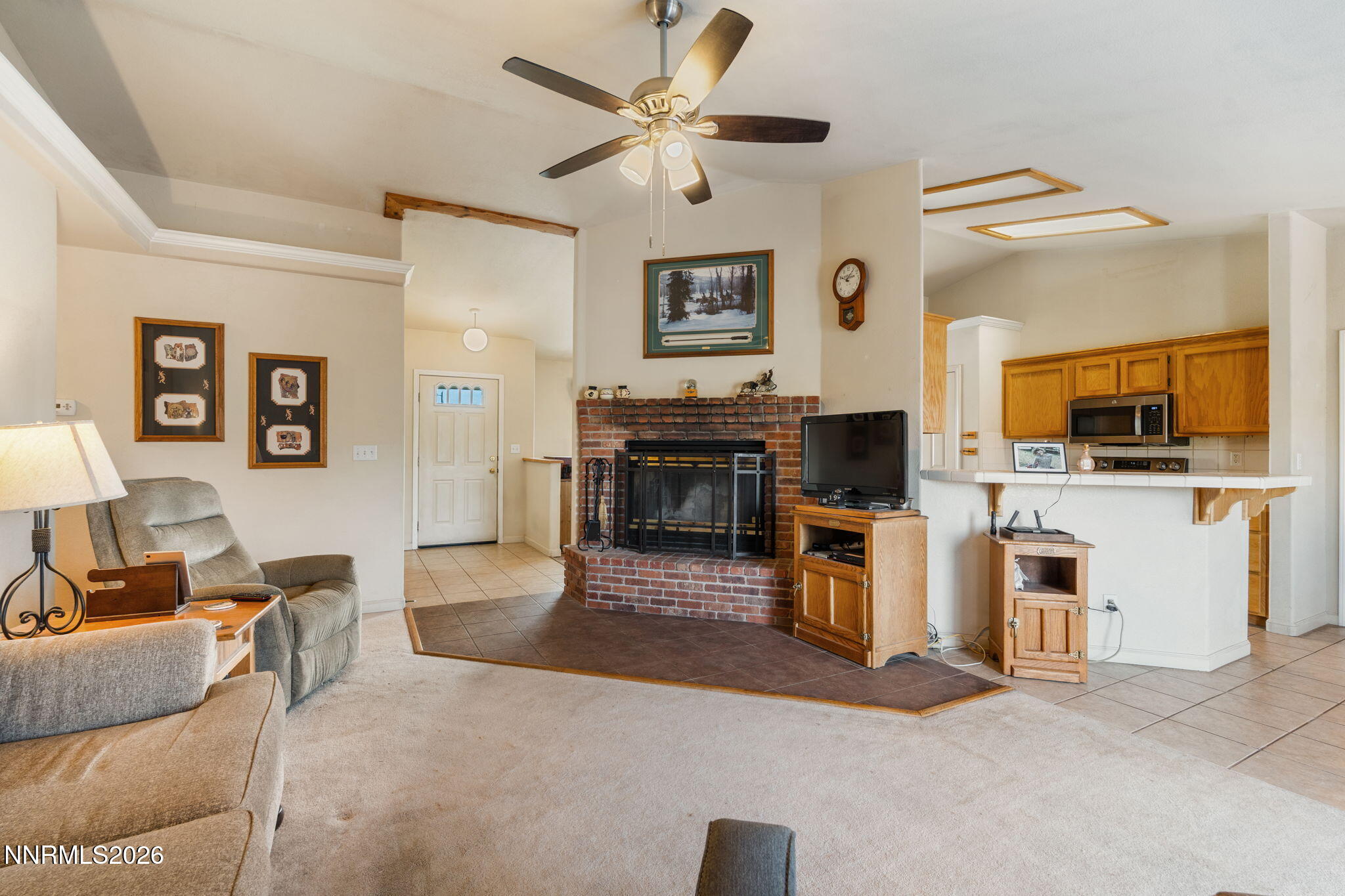 219 David Avenue Stagecoach, NV 89429 - Photo 7 of 40 a living room with furniture a flat screen tv and kitchen view