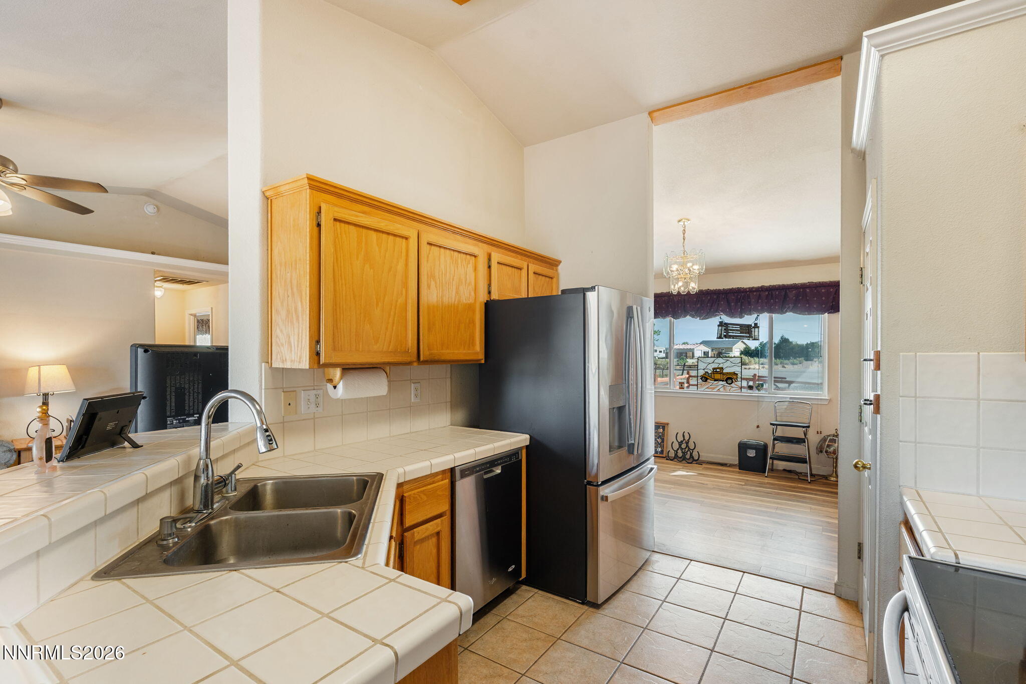 219 David Avenue Stagecoach, NV 89429 - Photo 8 of 40 a kitchen with stainless steel appliances a refrigerator sink and cabinets