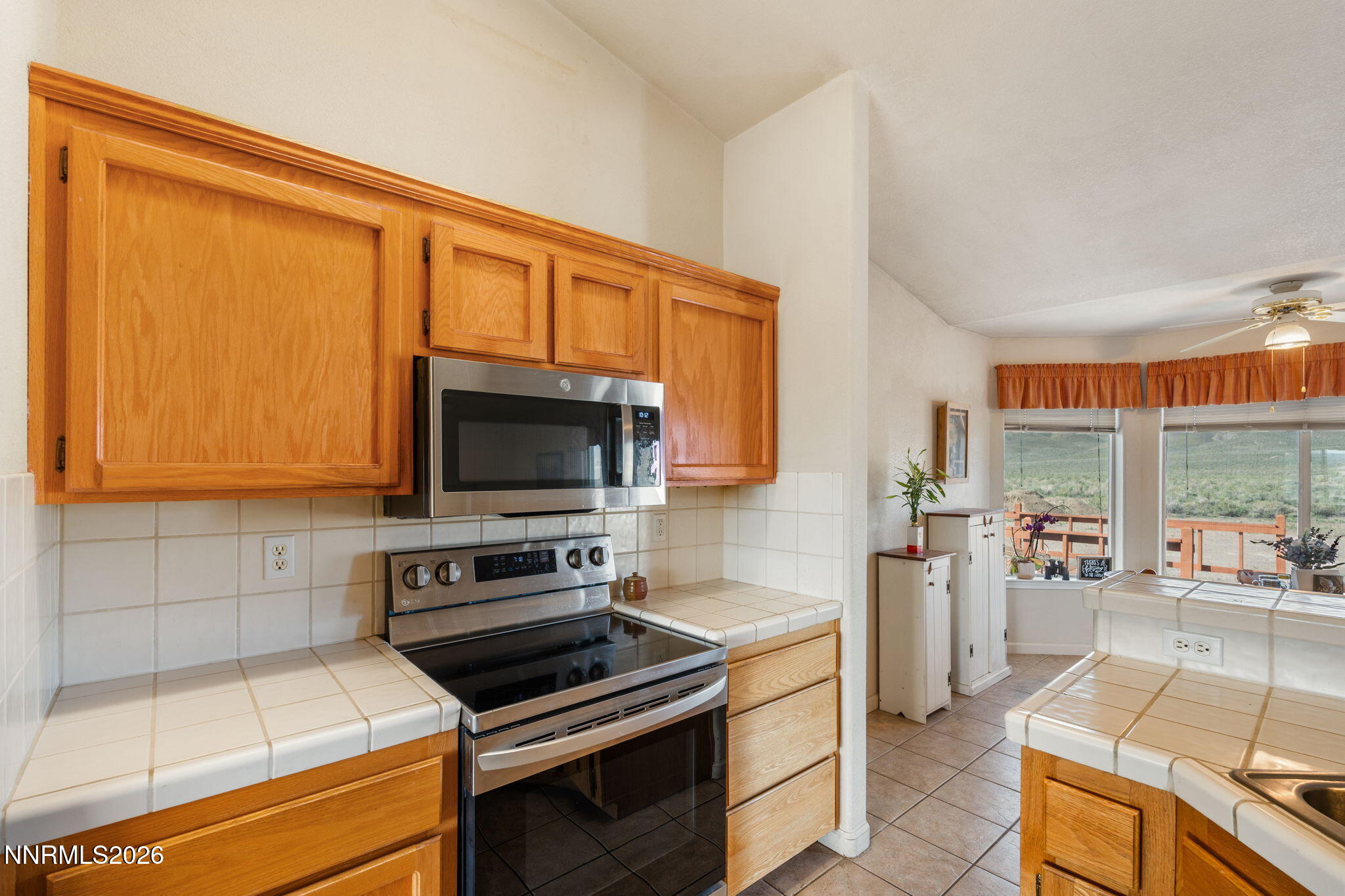 219 David Avenue Stagecoach, NV 89429 - Photo 9 of 40 a kitchen with a stove a sink and a microwave
