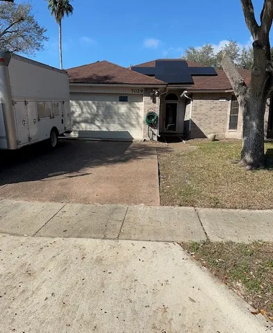 a front view of a house with parking space
