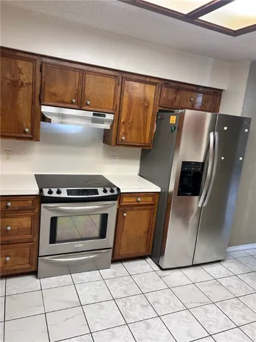 a kitchen with granite countertop a sink and a stove top oven