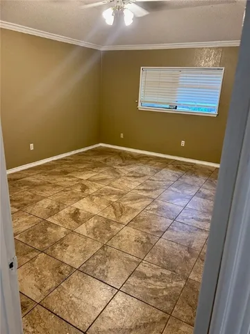 a view of a room with an empty space and a window