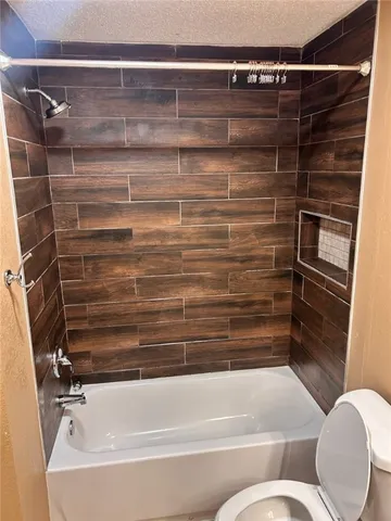 a bathroom with a toilet and bathtub