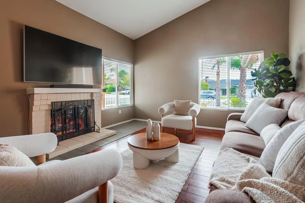 14230 Match Point Drive Poway, CA 92064 - Photo 11 of 70 a living room with furniture a flat screen tv and a fireplace