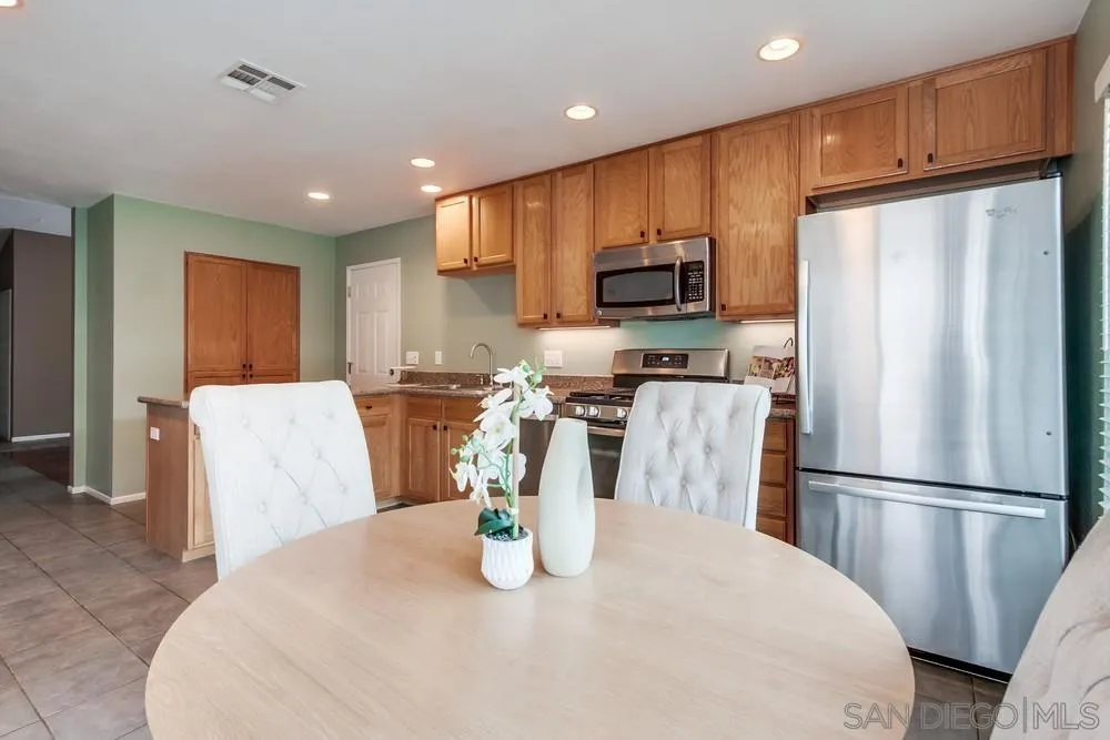14230 Match Point Drive Poway, CA 92064 - Photo 15 of 70 a kitchen with stainless steel appliances granite countertop a refrigerator a stove top oven a sink and a refrigerator