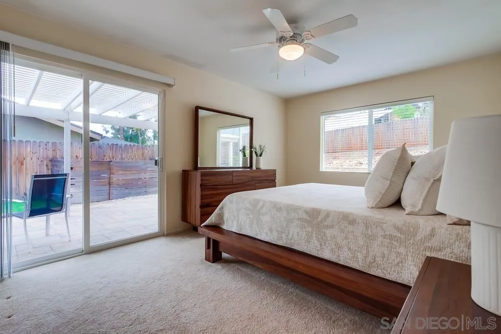 14230 Match Point Drive Poway, CA 92064 - Photo 17 of 70 a bedroom with a large bed and a chandelier fan