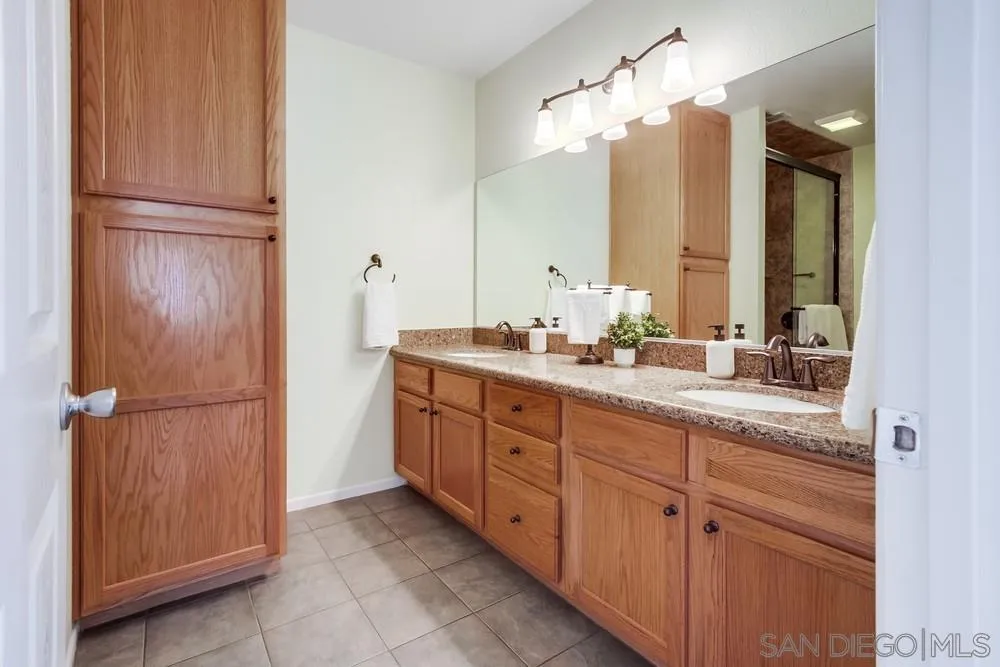 14230 Match Point Drive Poway, CA 92064 - Photo 20 of 70 a bathroom with a double vanity sink and a mirror