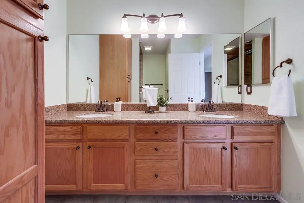 14230 Match Point Drive Poway, CA 92064 - Photo 21 of 70 a bathroom with a granite countertop sink and a mirror