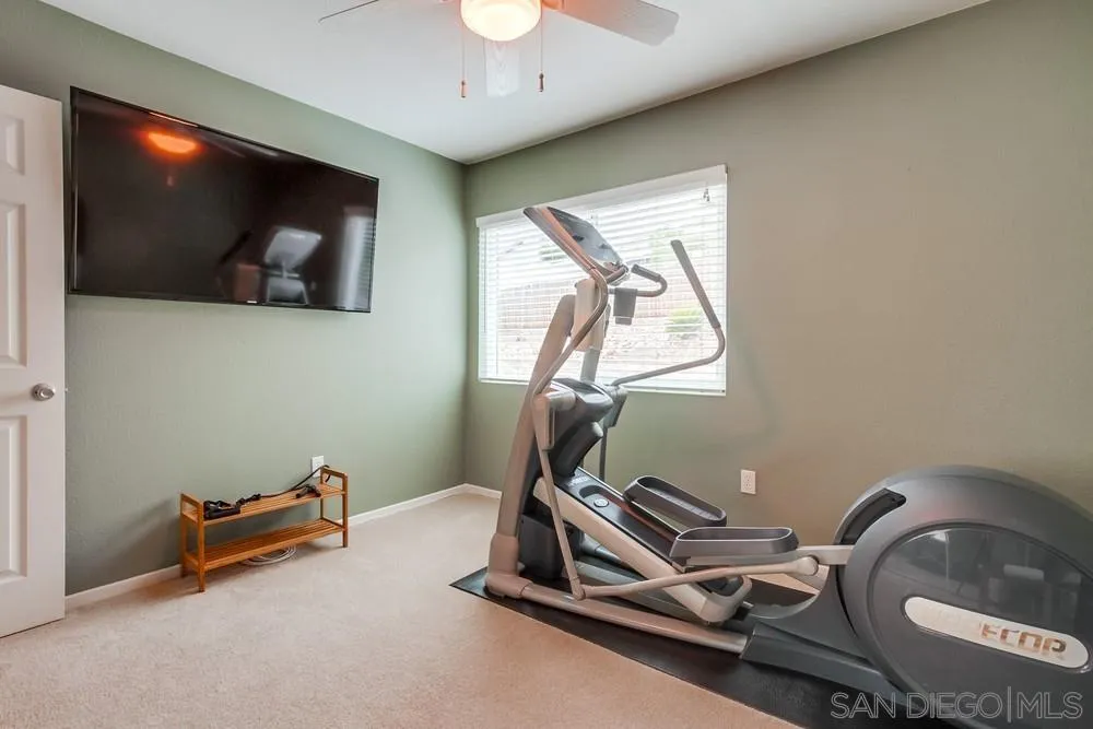 14230 Match Point Drive Poway, CA 92064 - Photo 25 of 70 a room with gym equipment and a flat screen tv