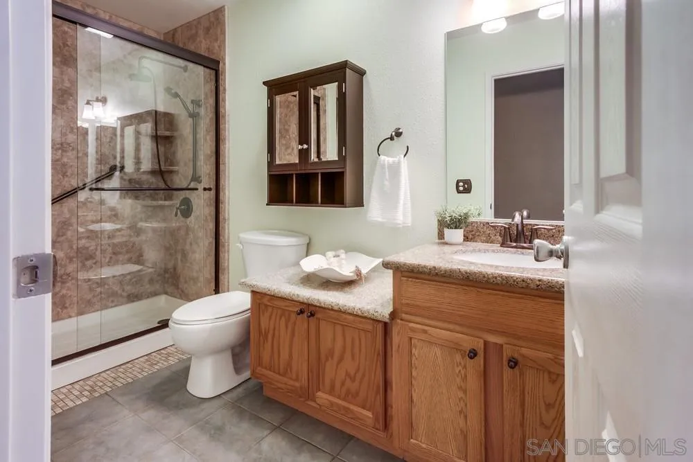 14230 Match Point Drive Poway, CA 92064 - Photo 28 of 70 a bathroom with a granite countertop toilet sink and mirror