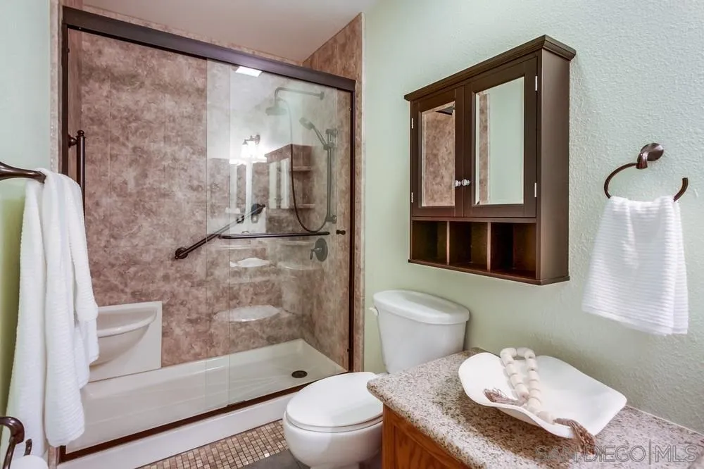 14230 Match Point Drive Poway, CA 92064 - Photo 29 of 70 a bathroom with a granite countertop sink mirror vanity and toilet