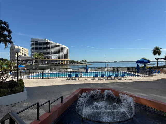 a house view with a swimming pool and sitting space