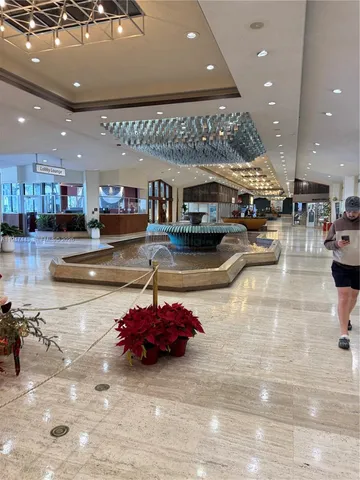 a living room with stainless steel appliances furniture a kitchen view and a kitchen view