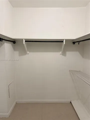 a view of a closet with racks on the wall