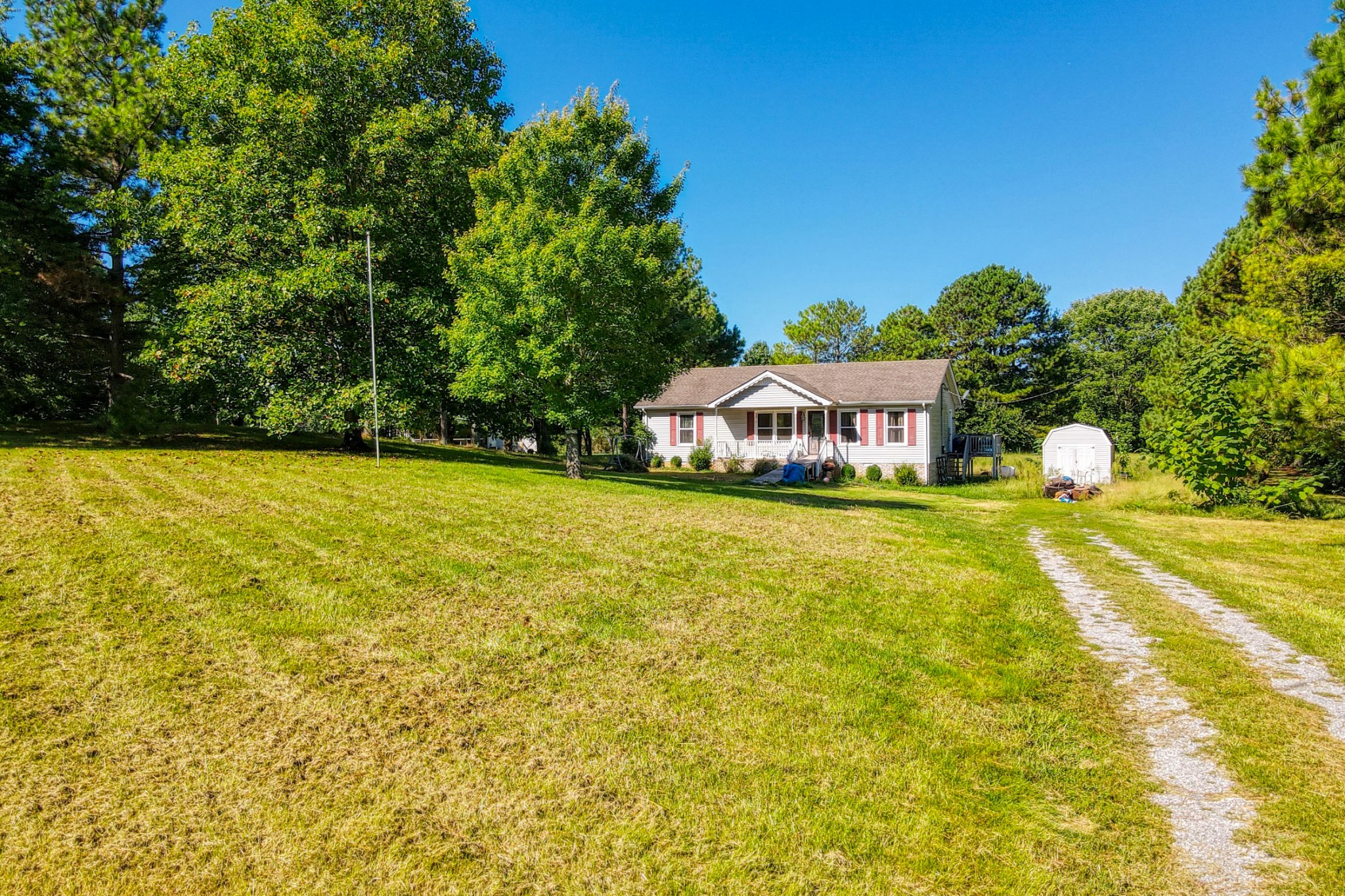 5130 Youngville Road Springfield, TN 37172 - Photo 1 of 15 a view of swimming pool with lawn chairs and large trees