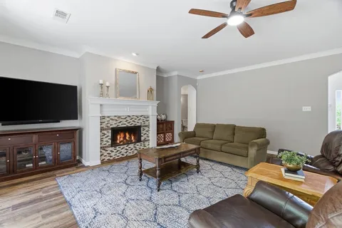 a living room with furniture a flat screen tv and a fireplace