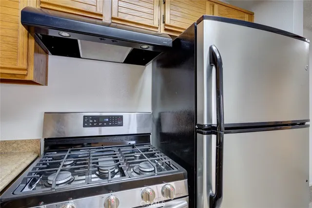 a view of a hallway with closet and wooden floor