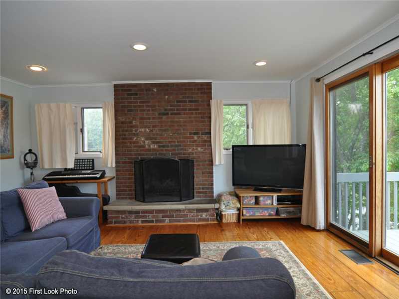 50 Sloop Street Jamestown, RI 02835 - Photo 3 of 25 Living Room. Cozy fireplace and recessed lighting
