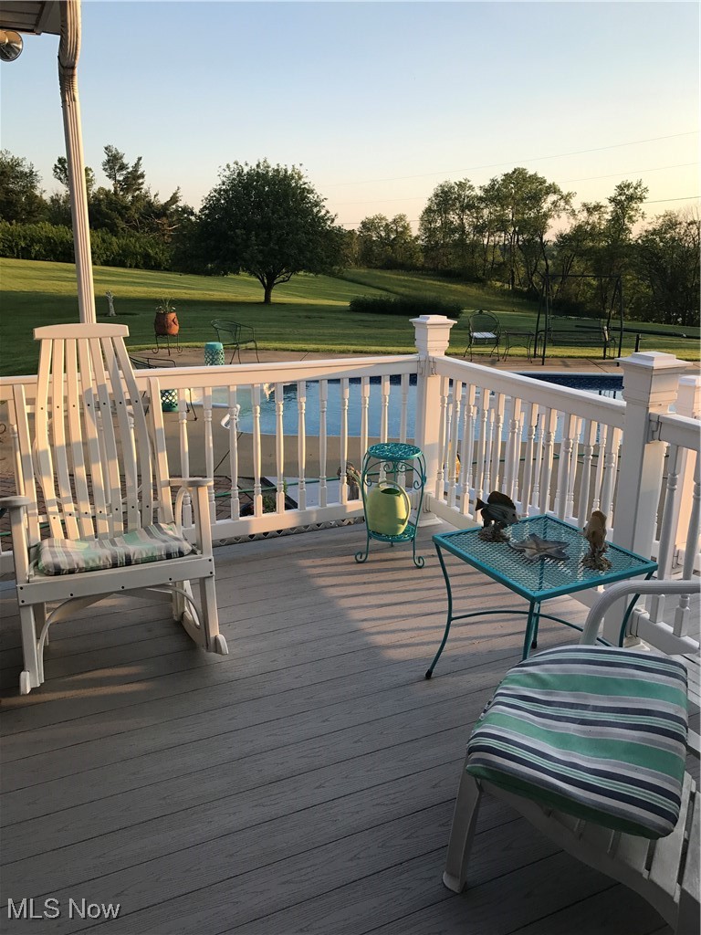 10004 Candy Road Cambridge, OH 43725 - Photo 2 of 20 Deck at dusk featuring view of wooded area