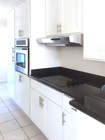 a kitchen with granite countertop a cabinets and steel appliances