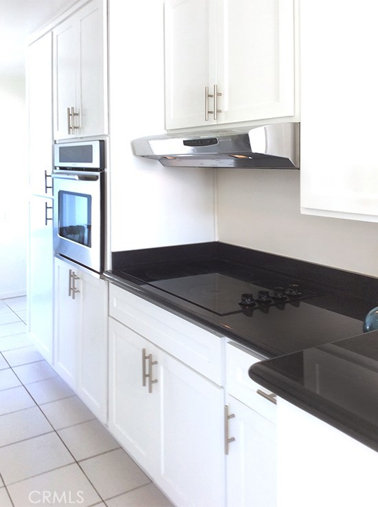 811 6th Street, Unit 305 Santa Monica, CA 90403 - Photo 13 of 25 a kitchen with granite countertop a cabinets and steel appliances
