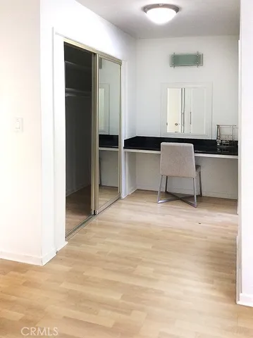 a view of a kitchen with kitchen island and stainless steel appliances