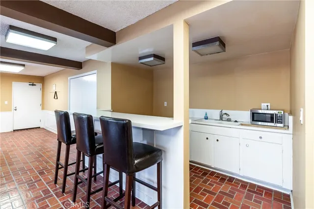 a kitchen with a dining table chairs and white cabinets